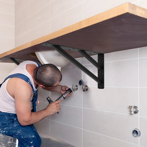Two Pack Rock Solid Shelf Brackets 16 By 12 Inch Wall Mounted Heavy Duty Floating Support Braces Matte Black Steel Braces installed under a countertop.