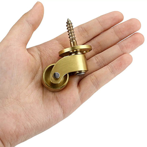 Heavy Duty Solid Brass Swivel Caster Wheels 4 Pack Vintage Furniture Casters With Rock Solid Structure Silky Smooth 360 Rotation Screw Mount in hand.