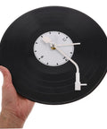 Hand holding vinyl clock showing Vinyl Record Clock Replacement Parts Kit With Movements, Hands, And Long Shafts For Easy DIY Repair