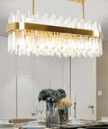 Slick Fresh Oval Glow Dimmable LED Pendant Light Adjustable Hanging Ceiling Fixture For Dining Room And Kitchen Top Shelf Gold Steel Chandelier with crystal accents.