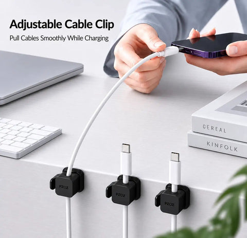 Person using Six Pack Cable Organizer Clips with No Residue Adhesive for neat and tidy desk, holding charger cable securely.