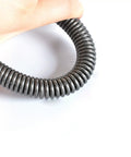 Hand holding a gray and black heavy duty dual hook tension spring, showcasing pack of 2 with 3mm wire and 18-20mm outer diameter.
