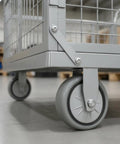 Beefed Up Heavy Duty Flatbed Wire Mesh Cart With Dual Handles And High Fence Sturdy Steel Construction Four Swivel Industrial Wheels Easy Haul For Steel Plates Up To 100 By 60 Heavy Load Trolley, close-up wheel and steel frame