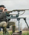 Man using Ambidextrous Recoil Reducing Rifle Shooting Rest With Elevation Adjustments For Range And Sighting In outdoors