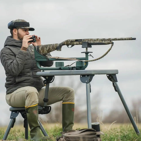 Man using Ambidextrous Recoil Reducing Rifle Shooting Rest With Elevation Adjustments For Range And Sighting In outdoors