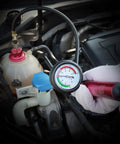 Cooling System Radiator Coolant Pressure Leak Tester Manual Hand Pump Gauge with gauge reading and reservoir in car engine.
