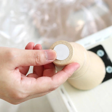 Person applying Tough As Nails 40 Pack Furniture Sliders Nail On Chair Leg Protectors For Wood And Hardwood Floors to chair.