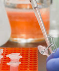 Spring Flow Control Tube Clamps With Bracket Feet For Lab And Classroom Use in lab setup with pipette and test tubes