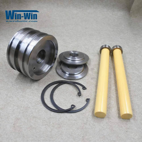 Waterjet piston assembly spare parts: two yellow rods, metal pistons, and O-ring seals.