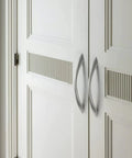 10 Pack Brushed Nickel Cabinet Pulls 6.3 Inch Arch Twisted Silver Handles installed on white closet doors