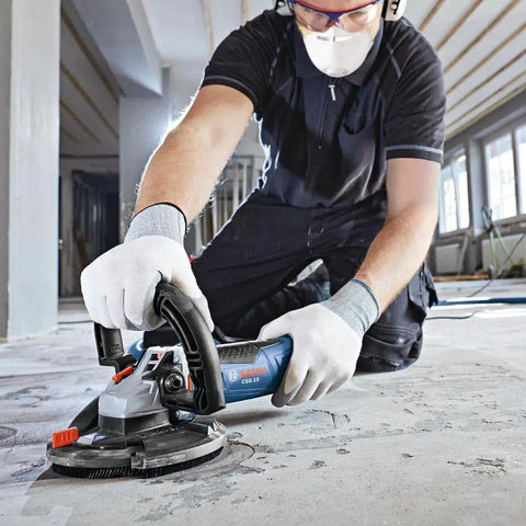 Worker using 5 Inch Diamond Cup Grinding Wheel For Concrete With Double Row Segments, optimized bond, in concrete surface prep