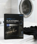 Black Fabric Dye Sheets 10 Pack That Restores Faded Clothes To Rich Black In Every Wash next to washing machine and shirt