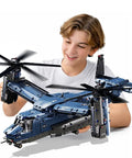 Teen boy with Military Helicopter Building Kit With Tiltrotor Inspired By The V22 Osprey Aircraft Transform Model