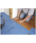 Man installing laminate flooring over Heavy Duty Sound Dampening Underlayment Roll For Laminate And Hardwood Floors 3MM Thick.