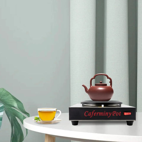 Professional Stainless Steel Coffee Warmer Plate, 80W Electric Mug Heater For Desk And Home with a teapot on a table.