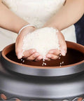 Person pouring rice into a Ceramic Rice Dispenser With Heavy Duty Snap Lid Airtight Bulk Food Storage Container.