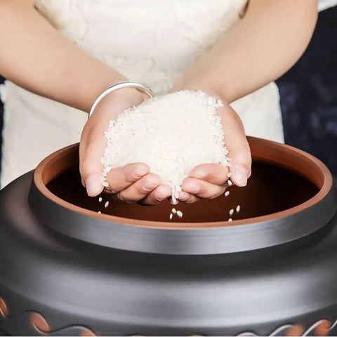 Person pouring rice into a Ceramic Rice Dispenser With Heavy Duty Snap Lid Airtight Bulk Food Storage Container.
