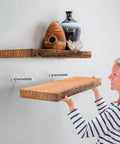 Person installing shelf using Isemble Floating Shelf Drill Guide Self Centering Jig for precise shelf installation and alignment
