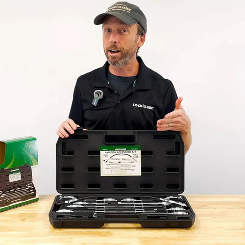 Man displays open case of 11 Piece Pro Grease Gun Adapter Kit For Aviation Industrial Mining And Agricultural Equipment Precision Fittings For Hard To Reach Grease Points And Durable Heavy Duty Performance.