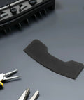 Pro-Grade Black Plastic Tire Shovel Cover for Tire Machine Repair Parts, Durable Shield Sleeve for Quick Tire Changes, Heavy Duty Protective Cover for Machine Accessories, black plastic tire shovel cover shown with shop tools