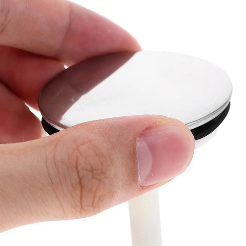 Bathtub Drain Stopper with Rotating Design and Silicone Seal Ring held in hand, showcasing its polished silver surface and seal.