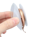 Hand holding Desoldering Wick Braid 1.5M No Clean Copper Solder Removal Tool For Electronics Repair And PCB Work High Temperature 3.0mm 3015A Premium Alloy For Pro Grade No Fuss Heat Transfer And Easy Component Rework on white spool.