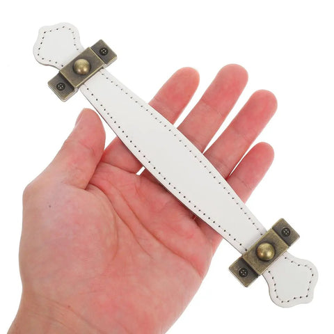 Person holding a Slick Vintage Zinc Alloy Cabinet Pull with White PU Leather Grip