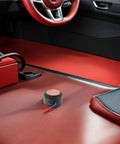 Slap This Auto Fire Suppressant Disc Straight Up On Dashboards Or Beneath Hood Panels, compact aluminum unit in car with red interior.