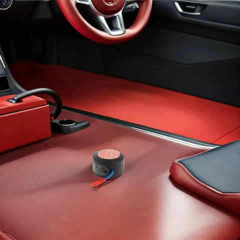 Slap This Auto Fire Suppressant Disc Straight Up On Dashboards Or Beneath Hood Panels, compact aluminum unit in car with red interior.