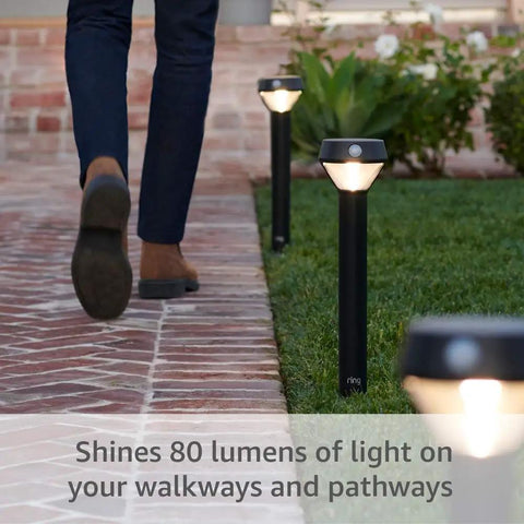 Slick Solar Pathlight Featuring Motion Activated 80 Lumen Bright Led Bulbs in a black fixture illuminating a garden walkway.
