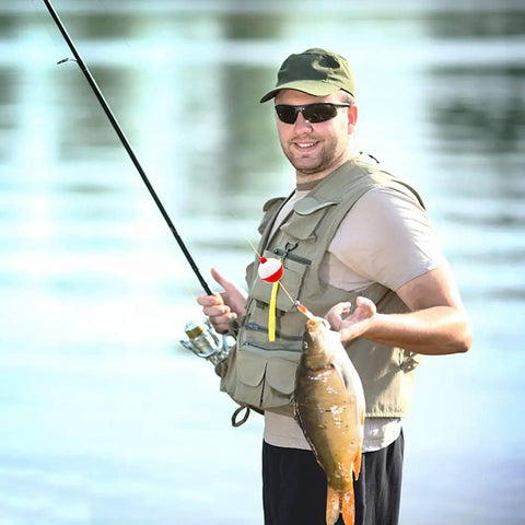 Person holding fish using 60 Piece Fishing Floats Set Hard ABS Push Button Round Buoys For Tackle Accessories One Inch And One And A Half Inch Red