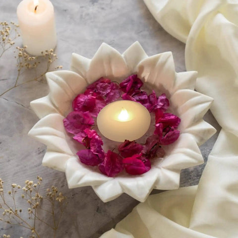 Pack Of 4 Wax Flickering LED Floating Candles 3 Inch Tealights Waterproof Warm White Battery Operated Flameless Candles For Dope Centerpieces Weddings Pool Parties Decor in a white flower-shaped bowl with petals
