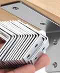 10 Pieces Iron Right Angle Corner Brackets For Furniture Cabinets Tables And Chairs Connectors Fasteners Hardware Accessories Durable 90 Degree Support For Shelves Frames And Projects shown installed and in hand for size comparison.