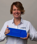 Person holding blue Heavy Duty Stackable Plastic Storage Bin, 11x4x4 inches, ideal for garage or pantry organization, 20 lb capacity.