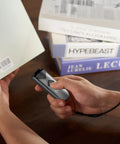 Portable Bluetooth 2D And 1D Barcode Scanner Mini Wireless Handy Reader scanning barcode on book at a library table
