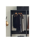Freestanding Wooden Closet System Featuring Modular Cubbies And Hanging Rods Delivers Totally No Sweat Customizable Wardrobe Storage For Clothes Shoes And Accessories In Sleek Gray with hanging dresses and tops.