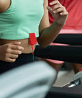 Person using treadmill with red Treadmill Safety Key With Magnet Lock Replacement Kit clipped to waist