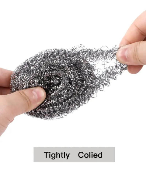 Close-up of Heavy Duty Stainless Steel Scrubber Pads held in hand, showing tightly coiled spiral wire for tough kitchen scrubbing