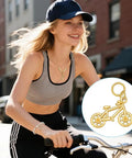 Smiling woman cycling with 18K Gold Plated Bicycle Charms Set With 4 Pieces Stainless Steel Double Sided Bike Pendants necklace