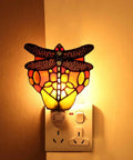 Tiffany Style Stained Glass Dragonfly Wall Lamp with Plug In Night Light Socket E12 LED Bulb Included, glowing in a dark room.