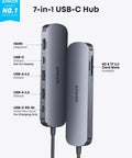 Side view of a 7-in-1 USB-C hub featuring HDMI, USB-A, USB-C ports, and SD/TF card slots, compatible with laptops and MacBooks.