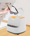 A hand holding sunglasses above the Straight Up Pro Grade Eyeglasses Frame Heater With Zero Fuss Ceramic Hot Air Warmer.