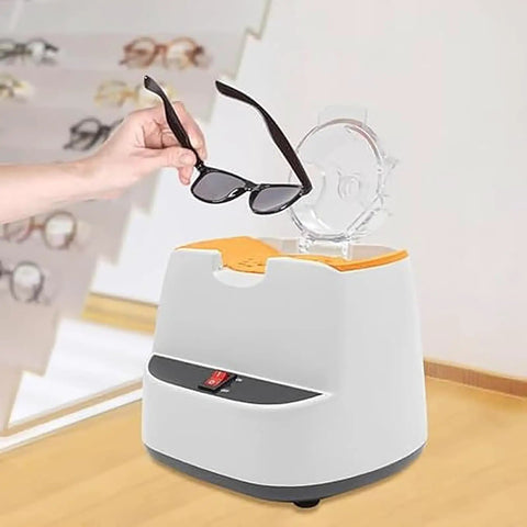 A hand holding sunglasses above the Straight Up Pro Grade Eyeglasses Frame Heater With Zero Fuss Ceramic Hot Air Warmer.