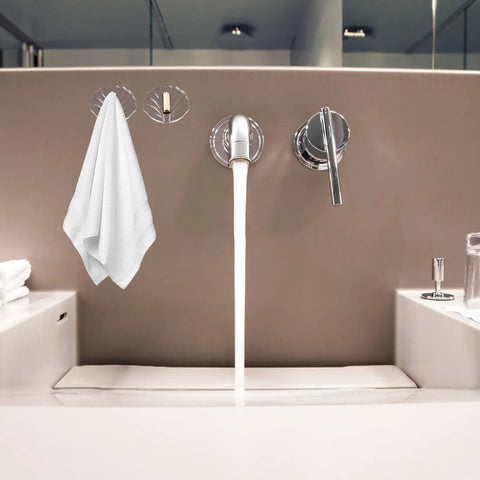 Six Pack Peel And Stick Wall Hooks With Rock Solid Hold For Zero Hassle Bathroom Setup Self Adhesive Hangers For Towels Hats Coats And Everyday Carry holding a white towel on a bathroom wall.