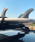 Soft Roof Rack Pads With Two 15 Ft Tie Down Straps For Surfboard, SUP Paddleboard, And Snowboard, installed on a car