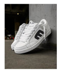 White black Kingpin 2K Skate Shoes with padded low top cupsole, size 8.5, showing durable reinforced stitching, street ready.