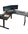 Rocking This VIVO L-Shaped Corner Standing Desk For Your Office Home Setup With Height Adjustable Ergonomic Features Smooth Transition From Sit To Stand Position Massive Workspace Ideal For Productivity And Comfort with two monitors, keyboard, and accessories.