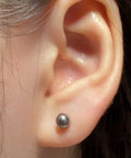 Titanium Earrings For Sensitive Ears 20G Implant Grade F136 Studs With Cubic Zirconia In Round Ball Princess Cut Square Shapes Nickel Free And Hypoallergenic Long Lasting Shine For Women And Men Who Want All Day Comfort And Style. round titanium stud earring worn in ear lobe