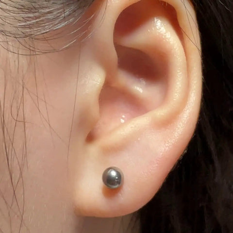 Titanium Earrings For Sensitive Ears 20G Implant Grade F136 Studs With Cubic Zirconia In Round Ball Princess Cut Square Shapes Nickel Free And Hypoallergenic Long Lasting Shine For Women And Men Who Want All Day Comfort And Style. round titanium stud earring worn in ear lobe