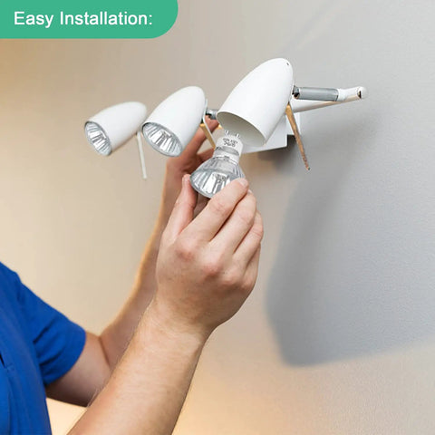 Person installing GU10 120V 25W Halogen Bulbs For Wax Warmer Scent Melt Candle Warmer in a wall fixture, showcasing easy installation.